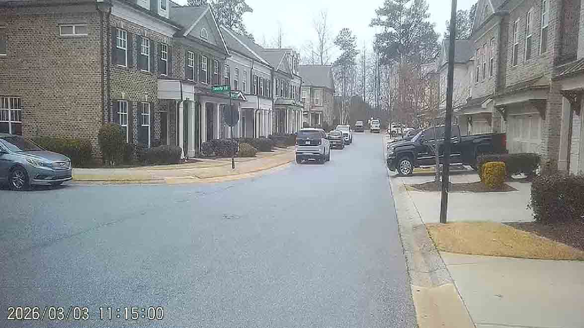 Two cars parked directly in front of fire lane sign