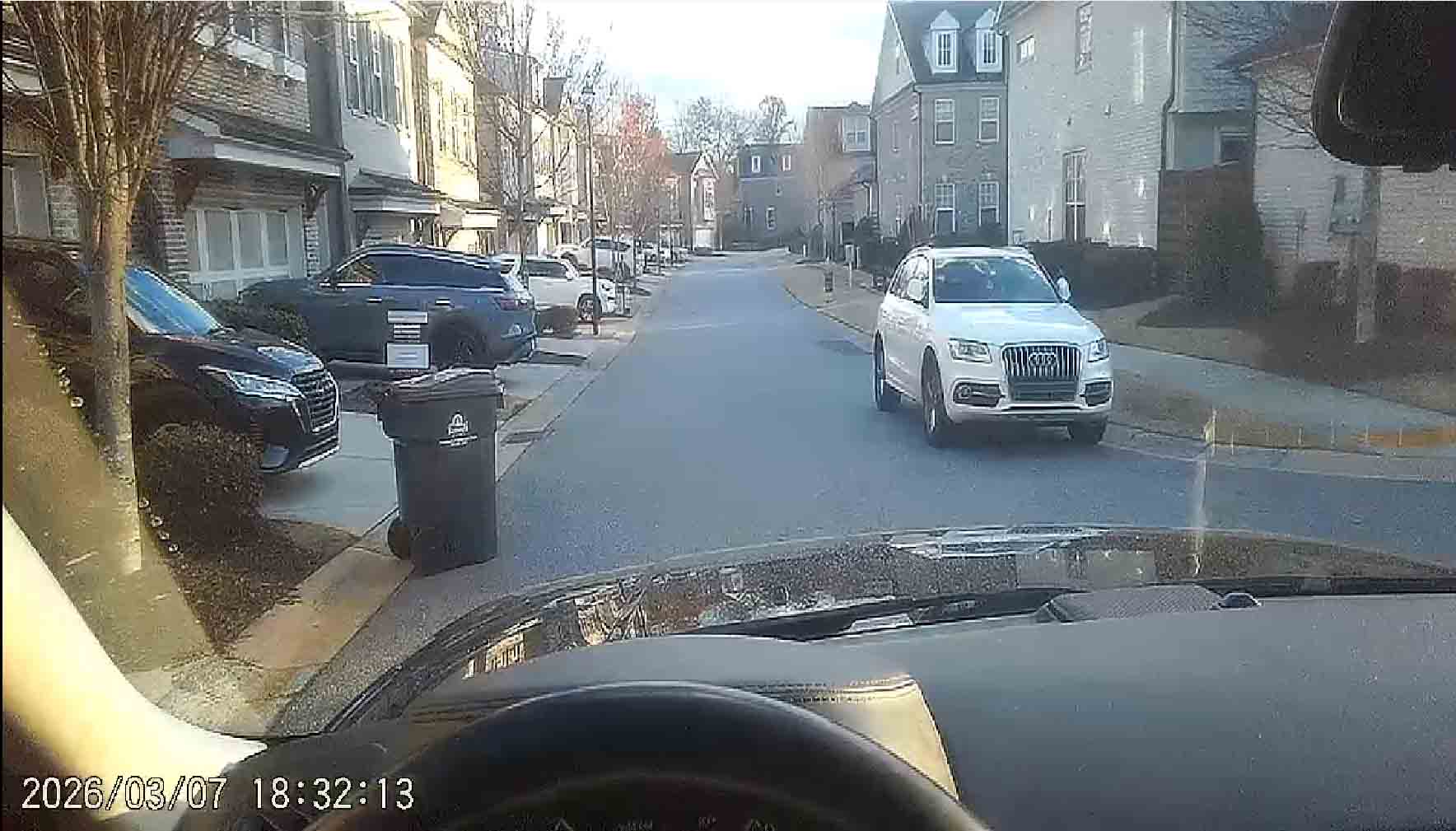 Trash Bin + White Audi in streets at Roswell Towneship